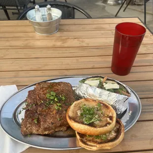 Vegan meatloaf, loaded baked potato and garlic bread