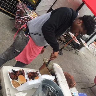 My eldest son preparing two rib dinner orders