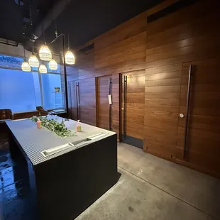 Bathroom is unisex with individual stalls and shared sinks