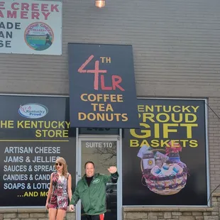 a man and a woman standing in front of a store