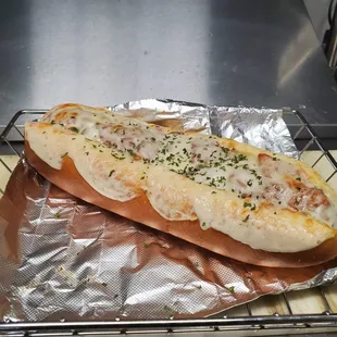 a hot dog with cheese and herbs