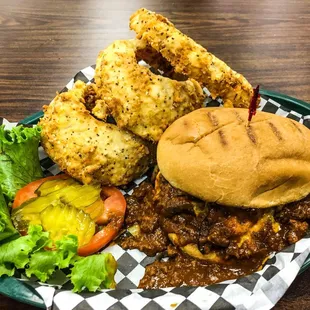 a plate of chili cheeseburger and fried chicken