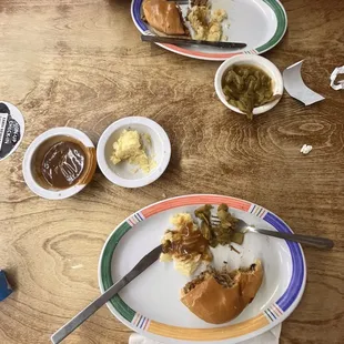 pulled pork sandwich with sides of mashed potatoes and green beans