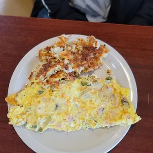 a plate of omelet and a piece of bread