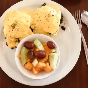 Eggs Benedict Florentine with a side of fruit. Delish!