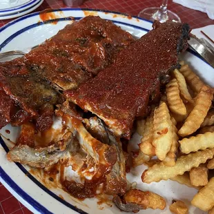 Full rack of Ribs with Fries.  The sauce resembles tomato paste more than BBQ sauce