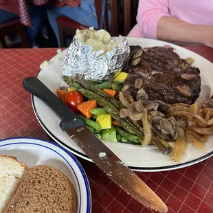 Rib Eye with veggies and baked potato.