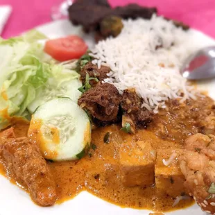 Goat curry, butter chicken, paneer, lamb, rice and salad.