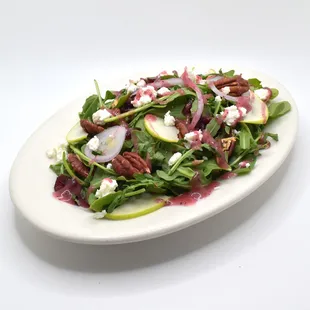 Arugula Salad, Pecan, Cranberry, Green Apple, Goat Cheese, Red Onion, Raspberry Walnut Vinaigrette.