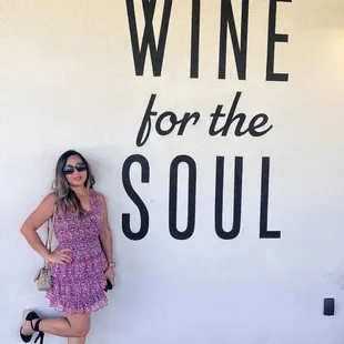 a woman leaning against a wall