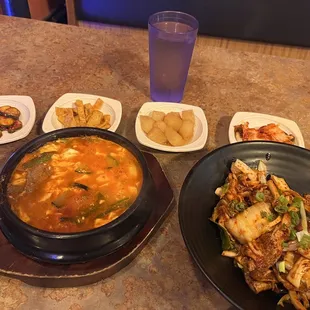 a bowl of soup and plates of food