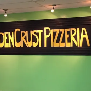 a sign that says golden crust pizzaria