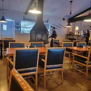 Part of the diningroom with wood burning fireplace. The new exterior windows don't make the room cold at all !!