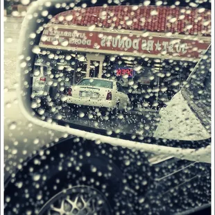 the reflection of a car in a rear view mirror