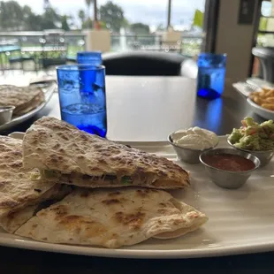 Quesadilla Especial: toasted tortilla, rosemary infused ham, turkey, tomatoes, olives, cheese with quacomole, sour cream and salsa!