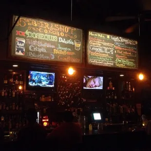 Specials and signature cocktail signs above the bar
