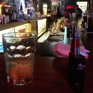 a glass of alcohol on a bar counter