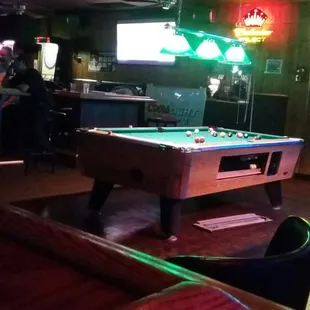 a pool table in the middle of a bar