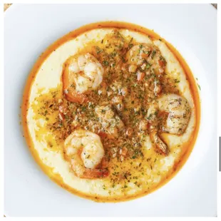 Shrimp &amp; Grits...

Creamy Cheddar Grits with Sautéed Shrimp tossed in our Special Sauce with Diced Tomatoes and Parsley.