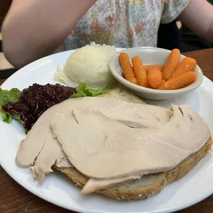 a turkey sandwich with carrots and mashed potatoes