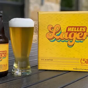 a glass of beer next to a box of miller&apos;s sugar