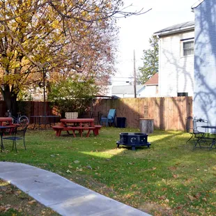 a backyard with picnic tables