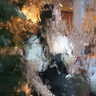 Bambi stantind with apple martini against the waterfall in the resturaunt