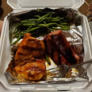 Combo plate. Dry chicken and sausage. Awful baked beans are under the foil. Green beans were good. Definitely not worth the money.