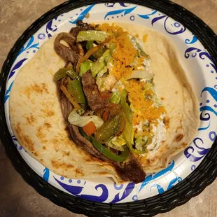 Steak fajitas $14.99. Come with Spanish rice &amp; beans, sour cream, guacamole, peppers, onions, tomatoes. And chips and salsa.