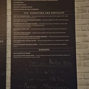 a menu on a brick wall