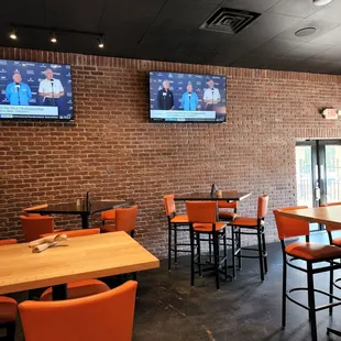 a brick wall with tvs