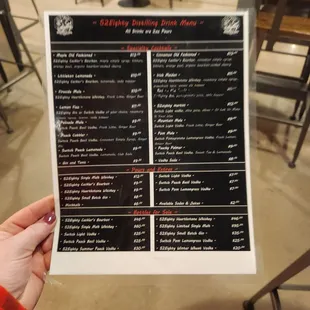 a person holding a menu