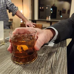 a man holding a glass of whiskey