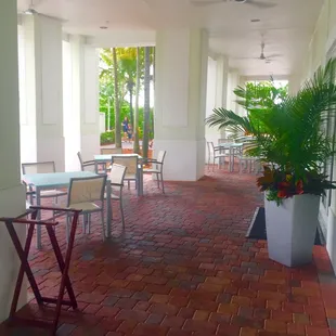 a patio with tables and chairs