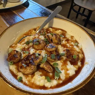 a bowl of grits and sauce