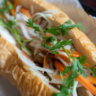 a sub sandwich with carrots and onions