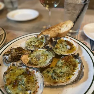 a plate of oysters with a side of bread