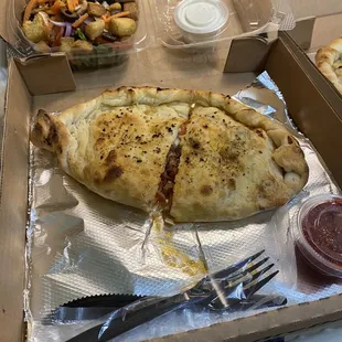 The Meats Calzone &amp; a House salad with Blue Cheese dressing.
