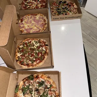 four pizzas on a table
