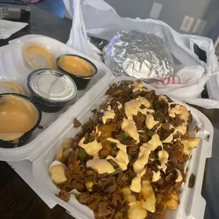 Crinkle French fries with steak, onions and peppers.. we added the sauce (either chimmi or chipotle)