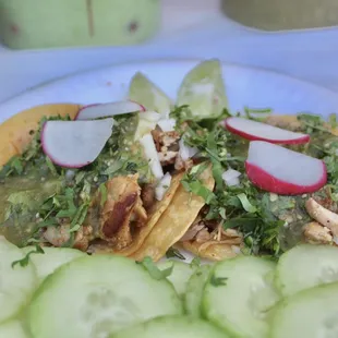 a plate of tacos and cucumbers
