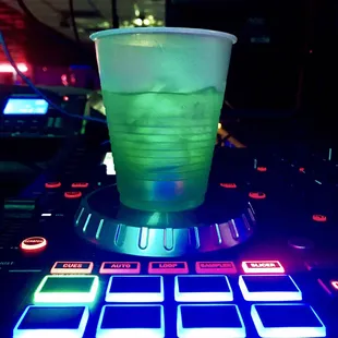 a green drink in a plastic cup