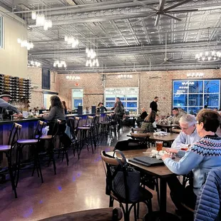 people sitting at tables in a restaurant