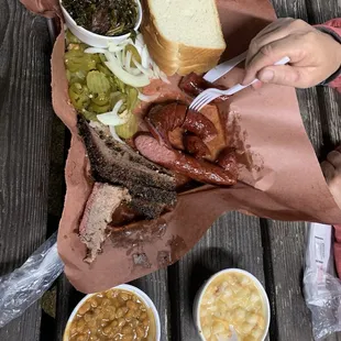 Brisket, sausage, baked beans, collard greens, and hominy