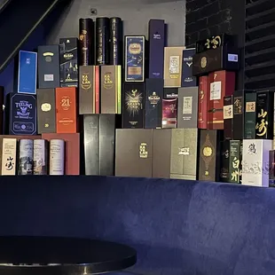 a wall of books and wine bottles