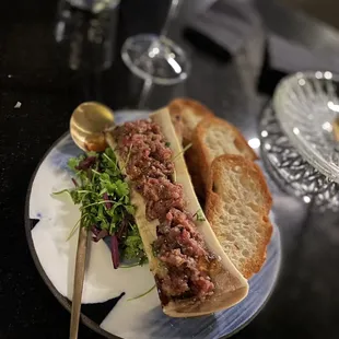 Bone Marrow topped with A5 Wagyu tartare, served with Acme ciabatta