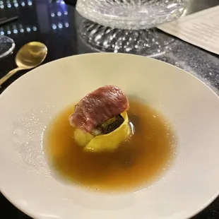 Wagyu dumpling topped with a slice of A5 Wagyu, with truffle-infused chicken broth