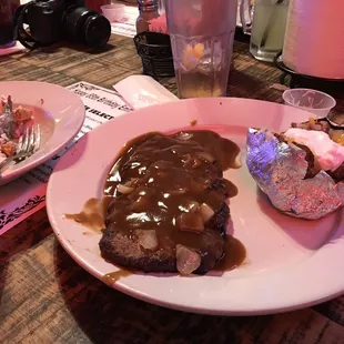 Hamburger steak, baked potato and salad.