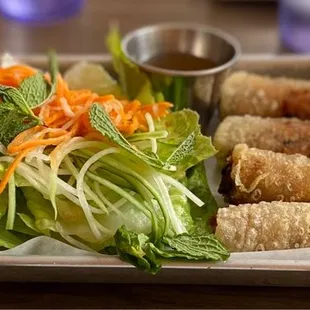 SPRING ROLLS.  Minced Pork &amp; Shrimp Filling  Served with Fish Sauce (Nuoc Cham)  Romaine, Pickled Veg. and Mint