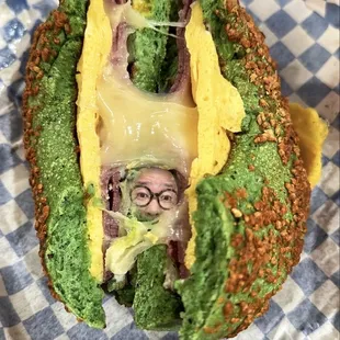 a sandwich with broccoli and cheese